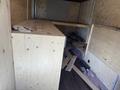 A 2009 Workhorse W62 truck interior showing wooden planks and an unfinished work surface with scattered materials