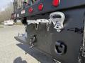 Rear view of a 2008 Kenworth T370 showing metallic hooks and chains attached to a black trailer hitch with reflectors and trailer lights
