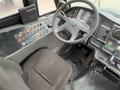 Interior view of a 2007 Freightliner B2 showing the driver's seat steering wheel and control panel with various buttons and gauges