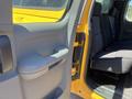A 2013 Chevrolet Silverado 1500 with a yellow exterior showing the interior door panel and back seat area