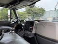 Interior of a 2012 International TerraStar showing the driver's seat dashboard steering wheel and control console