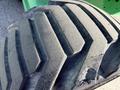 Close-up of a worn-out tire tread with deep grooves and textures designed for grip on a 2015 JLG 450AJ model