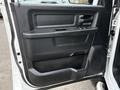 Interior door panel of a 2013 RAM 3500 featuring window controls a handle and storage compartment