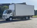 A white 2018 Hino 195 box truck with a closed cargo area and front cab facing towards the viewer