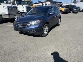 A blue 2013 Honda CR-V parked with a stylish design featuring a prominent front grille and sleek headlights