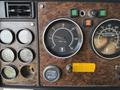 Dashboard of a 1996 Kenworth T800 showcasing various gauges including speedometer tachometer and oil pressure indicators with a woodgrain finish