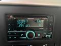 A Kenwood DPX504BT car stereo displaying the time as 10:01 and radio station information with blue backlighting and various control buttons