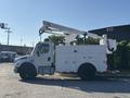 A 2006 Freightliner M2 106 bucket truck with a raised boom and a storage compartment on the side