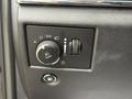 Control panel of a 2019 Jeep Grand Cherokee featuring light settings dial and a button for fuel release