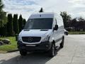 A white 2017 Mercedes-Benz Sprinter van with a high roof and black accents parked on a street