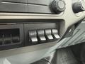 Close-up of the dashboard of a 2011 Ford F-650 featuring a series of four auxiliary switches labeled AUX 1 to AUX 4