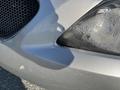 A silver 2006 Pontiac G6 with a cracked front bumper and a damaged headlight lens