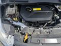 A 2015 Ford Escape with its hood open showcasing the engine compartment including the engine cover and various components