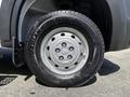 A close-up view of a silver wheel and tire from a 2021 RAM Promaster showcasing the tire tread and rim details