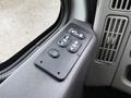 A control panel featuring buttons for window operation and locking on the interior of a 2011 International 7500 truck