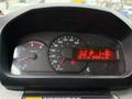 A vehicle dashboard showing a speedometer and tachometer along with digital readouts indicating mileage and other metrics