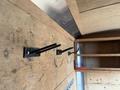 Interior of a 2016 Continental cargo trailer featuring wooden walls and three black metal hooks mounted on the side