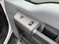Interior view of a 2012 Ford F-550 door panel showing window control switches and handle