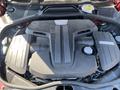 Engine of a 2015 Bentley Continental GT with a sleek design featuring a prominent Bentley logo and polished surfaces