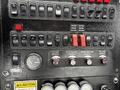 Control panel of a 2013 International DuraStar 4300 with various switches and gauges used for operating the vehicle's functions
