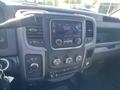 Interior dashboard of a 2015 RAM 2500 featuring controls for audio climate and navigation displays