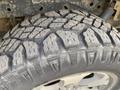Close-up of a heavily treaded tire from a 2014 Ford F-150 showcasing deep grooves and rugged design for off-road capability
