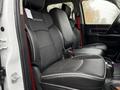 Interior view of a 2024 RAM 5500 with black leather seats featuring white stitching and a central console
