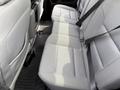 The interior back seating area of a 2018 Chevrolet Silverado 1500 with gray fabric seats and seat belts