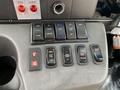 Dashboard controls of a 2020 Chevrolet Express featuring various buttons for doors lights aux fan and ramp function
