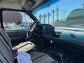 Interior of a 1996 GMC Top Kick with a cloth seat a steering wheel and dashboard displaying various controls and gauges