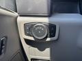 The image shows a control panel with a round dial and several buttons for adjusting lights on a 2022 Ford F-350 SD
