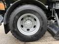Close-up of a tire from a 2009 UD Trucks UD 3300 showing a silver wheel with a central hub and black treaded tire labeled 11R22.5 XDE M/S