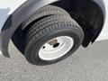 A close-up of a tire on a 2012 Ford Econoline showing tread pattern and wheel rim