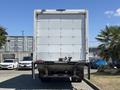 A white 2020 Hino 338 box truck viewed from the rear with a closed cargo area and visible hitch attachment