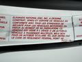A 2013 Chevrolet Express vehicle identification label detailing compliance with vehicle standards and usage as a multi-passenger bus rather than a school bus