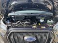 The image shows the engine compartment of a 2025 Ford Transit T-350 featuring a black grill and various components including hoses and reservoirs