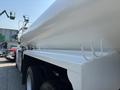 A 2008 Peterbilt 340 truck with a white cylindrical tank mounted on the back and hooks attached to the side