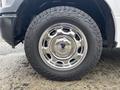 A chrome wheel rim of a 2020 Ford F-150 with a rugged tire tread design