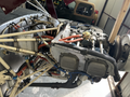 The image features the engine compartment of a 1986 Sorrell Hiperbipe SNS-7 Amateur-Built Aircraft with visible pipes wires and components connected to the engine