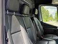 A 2022 Mercedes-Benz Sprinter with black leather seats in the front row and headrests positioned above each seat