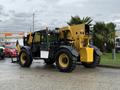 A 2014 Caterpillar TL1055C telehandler with large wheels and a yellow lifting arm positioned at the rear