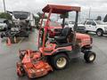 A red 2015 Kubota F3990 zero-turn mower with a roll bar and a single seat is positioned on a parking lot with a large mowing deck attached