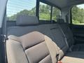 The image shows the back seat of a 2017 Chevrolet Silverado 1500 with grey fabric upholstery and seat belts visible