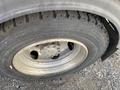 Close-up of the wheel of a 2019 Hino 195 showing the tire tread and metal rim with visible rust