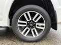 Close-up of a 2018 Toyota 4Runner wheel showcasing a silver and black alloy rim with a prominent Toyota emblem and a Geolandar tire
