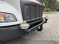 Front view of a 2025 Peterbilt 536 truck showcasing its distinctive grille and bumper with two cylindrical attachments on either side