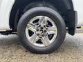 Close-up of a shiny chrome wheel with a five-spoke design mounted on a black tire featuring the General brand name and an all-season tread pattern