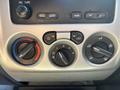 Dashboard controls of a 2011 Chevrolet Colorado featuring dials for temperature air flow and audio settings