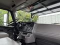 Interior view of a 2021 Freightliner M2 106 cab showing the steering wheel dashboard and control buttons