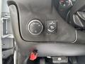 Dashboard controls of a 2020 Chevrolet Express featuring a headlight switch and an interior dome light control